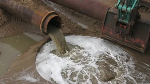Construction Site Excavator Next To  Water Flowing Out Of A Pipeline On The Stock Footage 150384527