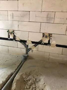 Construction Site with Exposed Plumbing and Light Colored Brick Wall Stock Photos