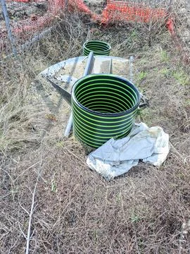 Construction site features black plastic manhole shafts with green rings ne.. Photos