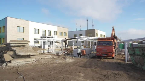 Construction site features concrete slabs and metal framing Stock Footage 306418170