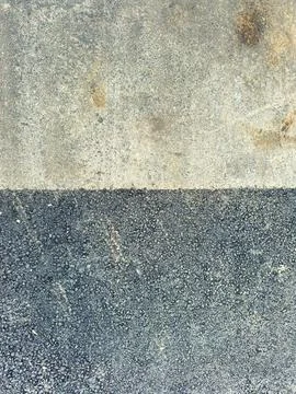 A construction site features a concrete surface with two distinct sections. T Stock Photos