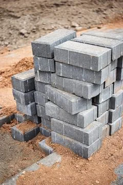 Construction site features stacked gray bricks arranged for building project 写真素材