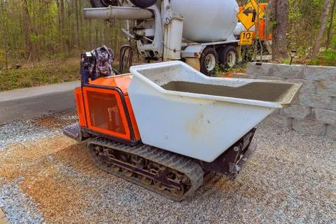Construction site features tracked dumper preparing to deliver concrete during Stock Photos