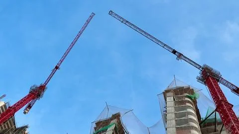 Construction Site Featuring Cranes and Building Progress Within an Urban En.. Stock Photos