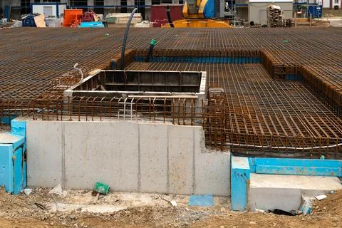 Construction site featuring foundation work and rebar installation Stock Photos
