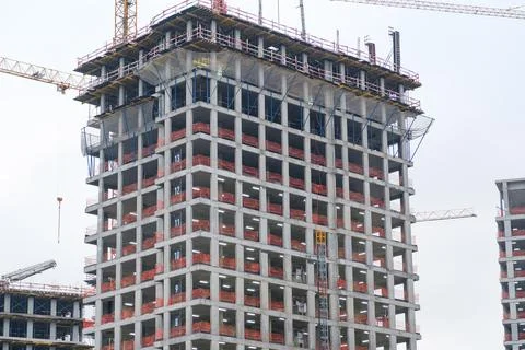 Construction site featuring a high-rise building under construction with cr.. Stock Photos