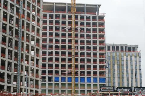 Construction site featuring a partially completed concrete building with Stock Photos