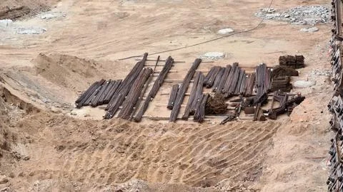 A Construction Site featuring Piled Materials, Heavy Machinery, and Ongoing.. Stockfoto's