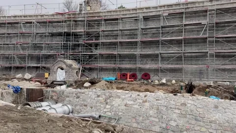 A construction site featuring scaffolding, materials, and various building Stock Footage 304835021