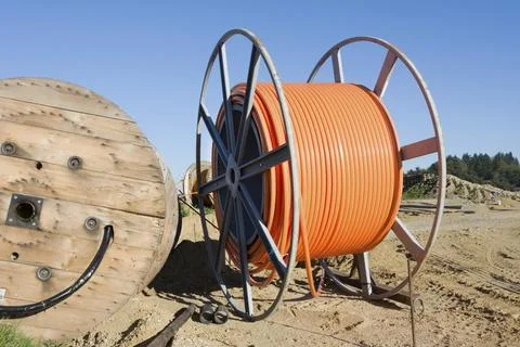 Construction site with a fiber optic cable roll for digital broadband internet Foto stock