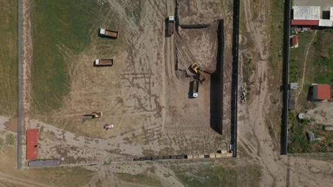 Construction site, foundation pit. Excavation, excavator pours earth with bucket Stock Footage 277932530