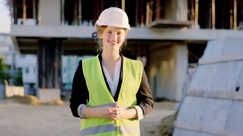 At construction site in front of the camera engineer lady looking straight to Video stock 144291589