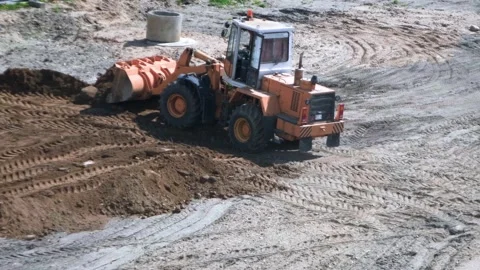 Construction site, front loader working at the construction site Stock Footage 242098620