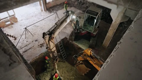 Construction site, a group of workers in helmets work with heavy drilling Stock Footage 263722502
