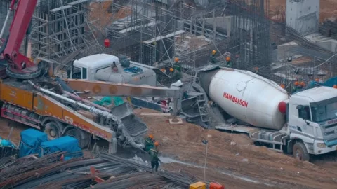 Construction site with heavy machinery, including concrete pump truck Stock Footage 340629609