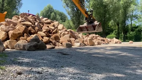 Construction Site Heavy Machinery Moving Rocks and Soil for Excavation Stock Footage 278399006