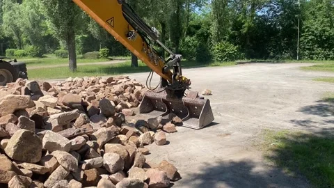 Construction Site Heavy Machinery Moving Rocks and Soil for Excavation Stock Footage 278399007