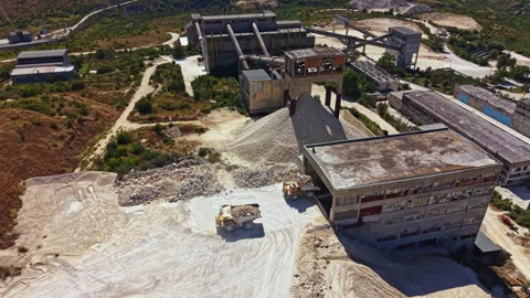 Construction site with heavy machinery working on gravel and materials in an Stock Footage 341075793
