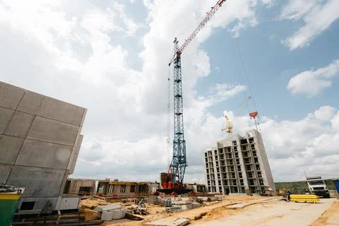 Construction site with high cranes. Construction of modern apartment building Stock Photos