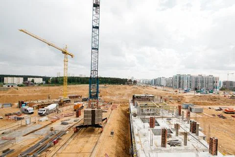 Construction site with high cranes. Construction of modern apartment building Stock Photos