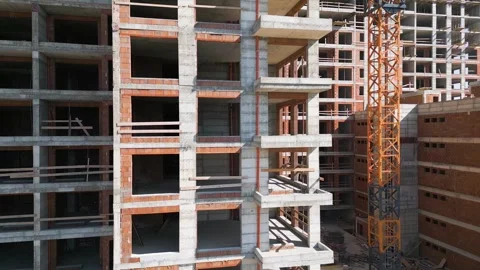 Construction site of a high-rise building at sunny day. The structure's concrete Stock Footage 304064243