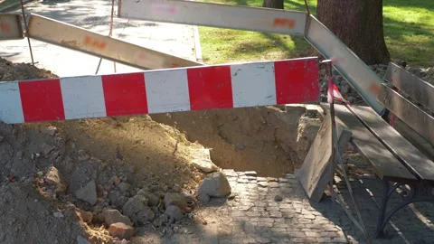 Construction site with a hole in the ground and safety barriers in 4k slow .. Stock Footage 282473043