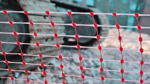 Construction site includes a colorful safety net with red and white mesh Stock Footage 338297748