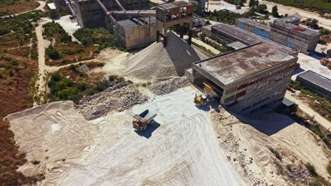 Construction site in an industrial area with heavy machinery moving materials Stock Footage 341075893