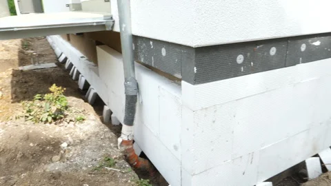 Construction site - insulation of a buildings foundation Видео 248060700