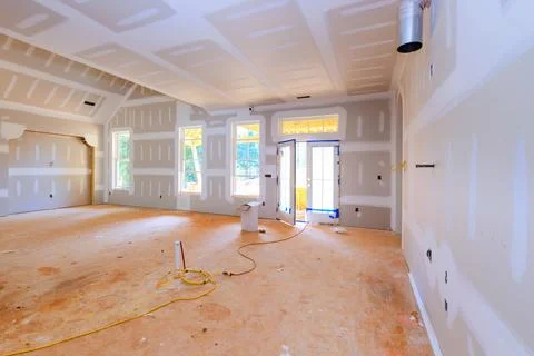 Construction site interior of house with drywall unfinished floor under ren.. Stock Photos