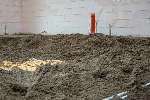 Construction Site Interior with Orange Pipe and Concrete Walls Stock Photos