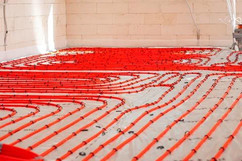 Construction Site Interior with Red Underfloor Heating Pipes 스톡 사진
