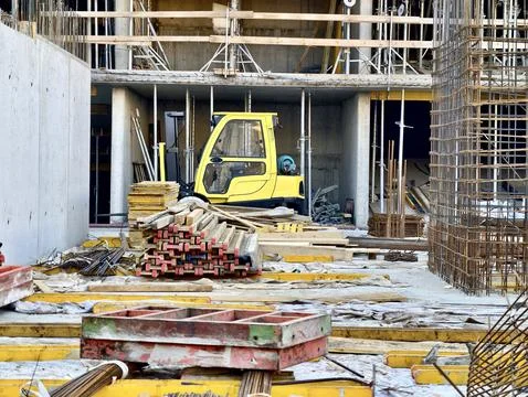 Construction site interior with stacked formwork, steel reinforcement, scaf.. Stock Photos
