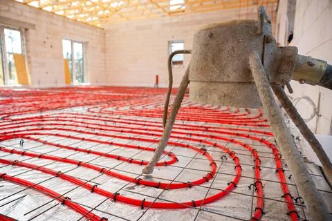 Construction Site Interior with Underfloor Heating Pipes and Concrete Mixer Stock Photos