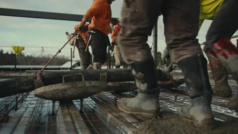 Construction Site: Laborers drag concrete line Vidéo 224949385