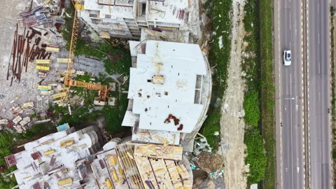 Construction site of a large building project near a busy road with vehicles Stock Footage 341374822