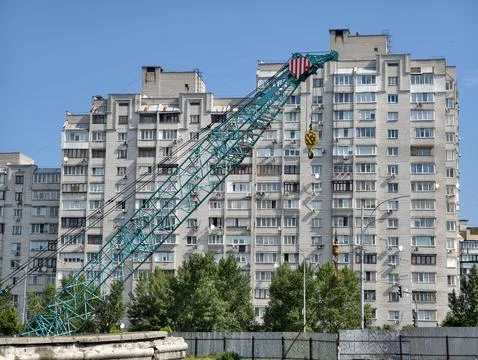 Construction site with large crane against residential building background .. Stock Photos