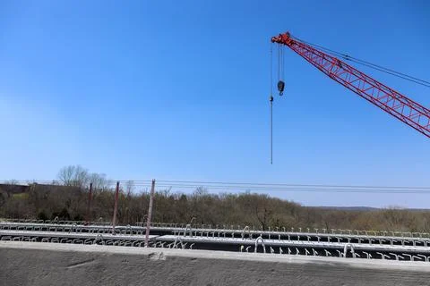 Construction site with large crane concrete bridge overlooking rural landscape Stock Photos