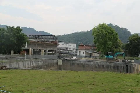 A construction site with a large green machine Stock Photos