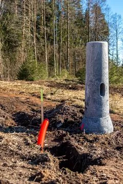 Construction Site with Light Pole Base and Forest Background Stock Photos