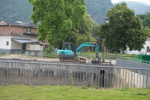 The construction site of the low-lying contoured dam in an urban area, with.. Stock Photos
