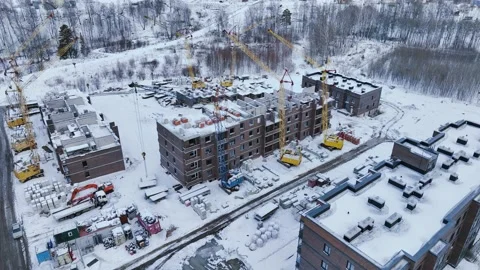 Construction site of low-rise brick houses in snowy winter Stock Footage 221910383