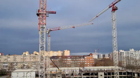 Construction site machinery lifting and moving materials to build Video stock 327158951
