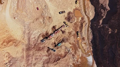 Construction site with machinery working in open area near canyon 動画素材 338240835