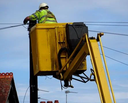 Construction Site Man On Cherry Picker Repaing Telephone Cables Stock Photos