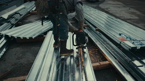 Construction Site: Man cuts metal panel as sparks shoot everywhere Stock Footage 225012202