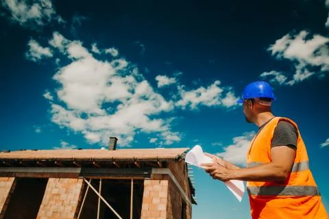 Construction, site manager overseeing construction of the new building with a 库存照片