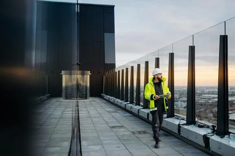 Construction site manager using digital tablet to inspect building progress. Stock Photos