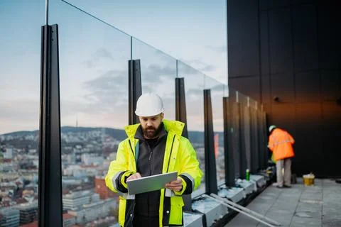 Construction site manager using digital tablet to inspect building progress. Stock Photos