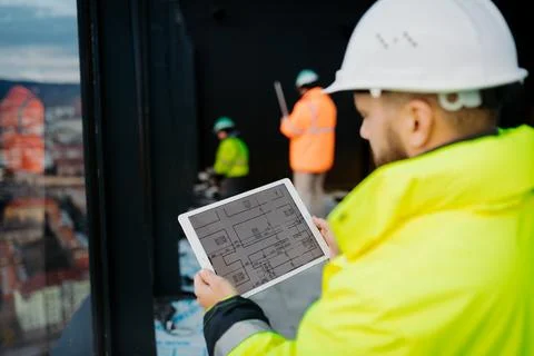 Construction site manager using digital tablet to inspect building progress. Stock Photos